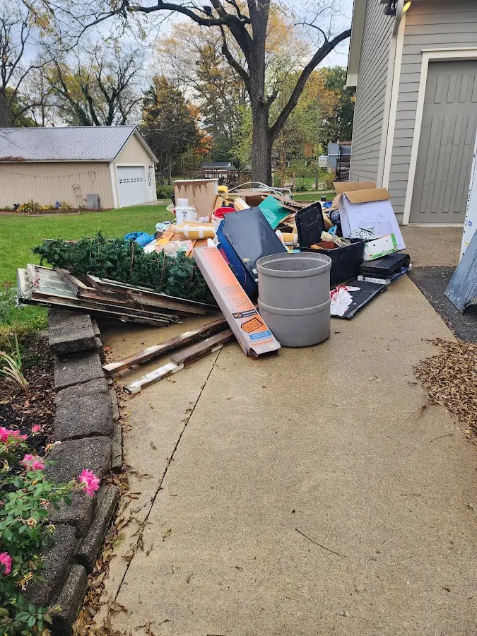 Dumpster being loaded with debris for Commercial Dumpster Rental in Bentonville